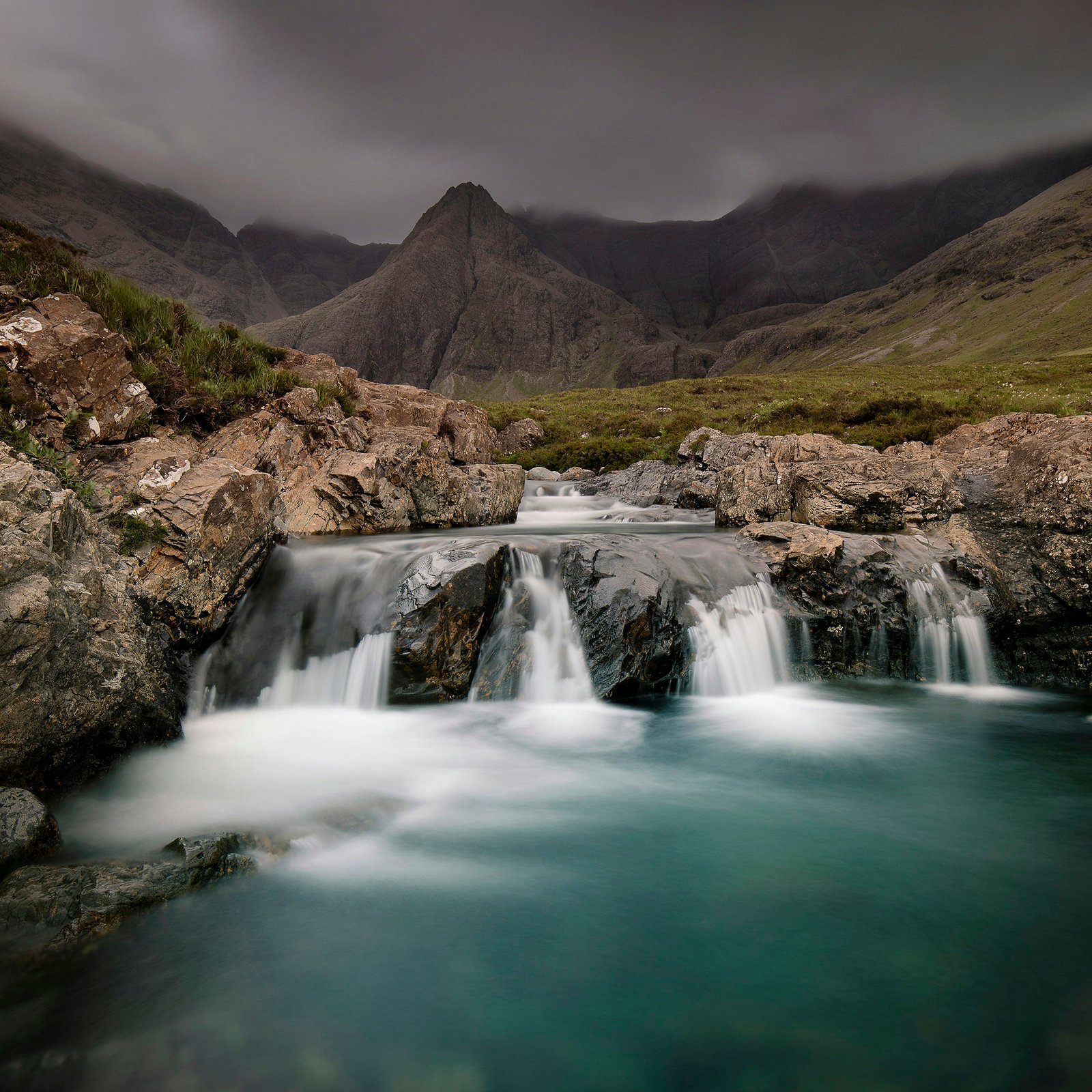 waterfalls surrounded by moutains